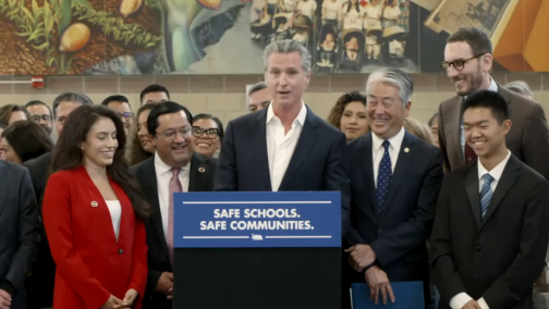 Senator Jesse Arreguín joins Governor Gavin Newsom at a bill signing ceremony.